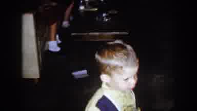 North Hollywood California (1961): Small Boy Wearing Yellow Shirt Stands Near Wood