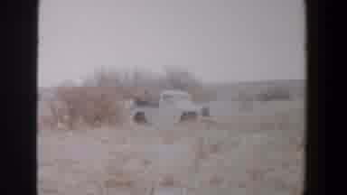 Lubbock Texas (1956): Shot Of A Van In The Countryside With Two People In The Back