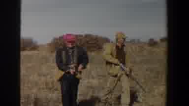 Lubbock Texas (1956): A Group Of Hunters With Rifles Walk In The Countryside