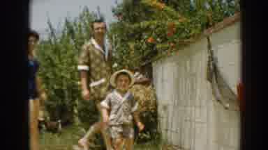 North Hollywood California-1961: Family Walking In Garden In 1960s Swimwear