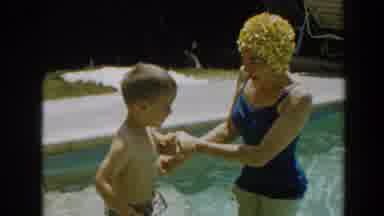 North Hollywood California (1961): A Woman Plays With Her Kid In The Pool Teaching