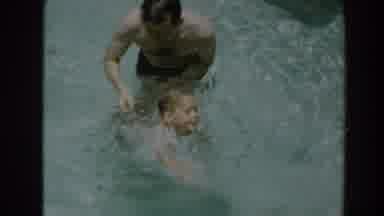 North Hollywood California (1961): Man Helps Child In Swimming Pool Boxer Walks