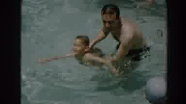 North Hollywood California (1961): A Man Swims In A Pool With Son As Another Woman