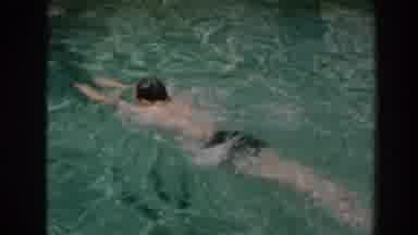 North Hollywood California (1961): A Male Swimming In A Pool With A Woman Standing