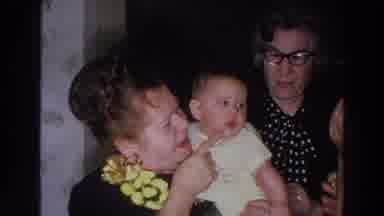 Madison Wisconsin (1966): Woman Wearing Black And Yellow Dress Holds Baby Wearing