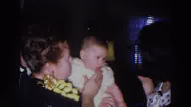 Madison Wisconsin (1966): Woman Wearing Black And Yellow Shirt Holds Baby Wearing