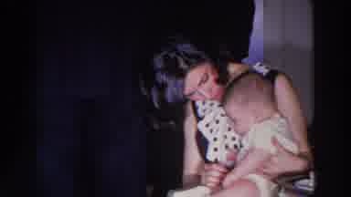 Madison Wisconsin (1966): Woman With Baby Using Tissue On The Baby While Sitting