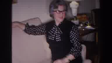 Madison Wisconsin (1966): A Man Talks To His Woman Sitting And The Couch Folding