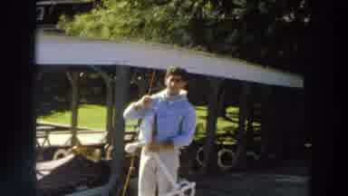 Madison Wisconsin (1966): Man Fishing On A Dock Showing Off His Catch With