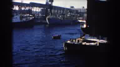 Dearborn Michigan (1960): A Large Ship Surrounded By Small Boats On A Water