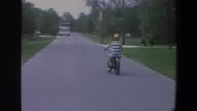 Minnesota (1973): A Boy Riding A Bike In The Streets Having Fun