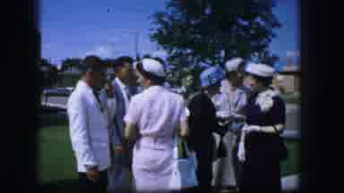 Moberly Missouri (1962): Small Group Of People Standing Near Green Tree Talking On