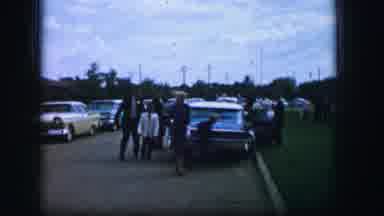 Moberly Missouri (1962): Woman In Blue Dress Walking On The Street Smoking In