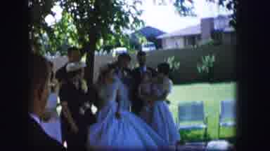 Moberly Missouri (1962): Woman Wearing White Wedding Dress Stands Near Green Tree