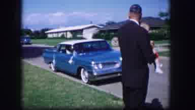 Moberly Missouri (1962): Man Suit Baby Woman Shadow Walking Car Road Houses Suburb