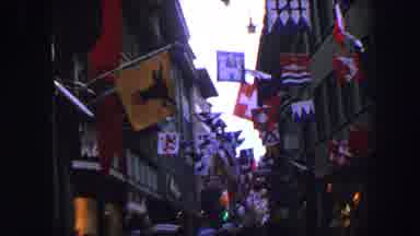 LUCERNE SWITZERLAND-1963: People Moving Around In The City Where Different Flags Hang