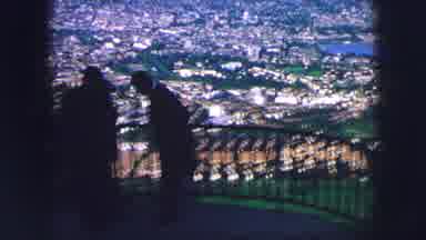 SAINT MORITZ SWITZERLAND-1963: Silhouetted Figures Overlooking City From Hilltop