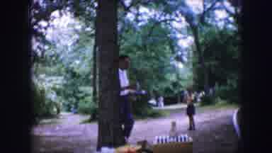 Dallas Texas (1964): A Man Walking And Eating His Meal In A Park