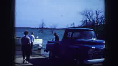 Fort Worth Texas (1964): People Unhitching White Boat From Blue Truck On A Bright