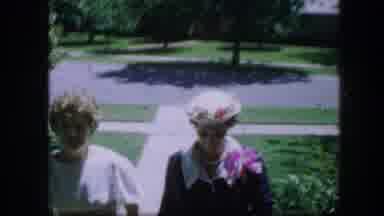Fort Worth Texas (1964): Two Ladies In Dresses Walking Towards A House And A Boat