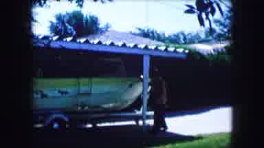 Lewisville Texas (1965): Two Guys With A Boat Outside Their House In A Windy Day