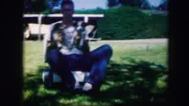 Kirksville Missouri (1967): White Middle Aged Man Holding Two Puppies Playing To