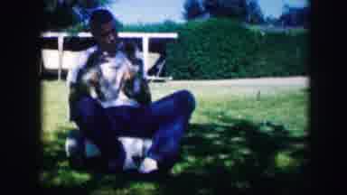 Kirksville Missouri (1967): A Man Holding Two Puppies As They Fight With