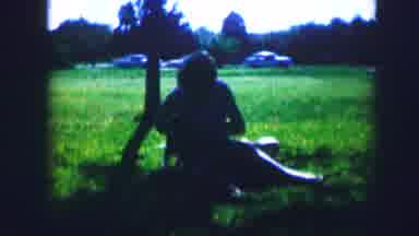 Kirksville Missouri (1967): A Woman Sitting Under A Tree Playing With Her Dog