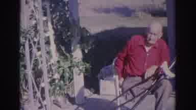 Sarasota Florida (1969): Man Wearing Red Shirt Sits In White Chair On A Bright