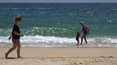 CABO SAN LUCAS MEXICO-2019: An Adult Woman Playing With A Child On The Shore