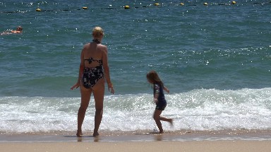 CABO SAN LUCAS MEXICO-2019: A Woman And Her Daughter Playing At The Water's Edge