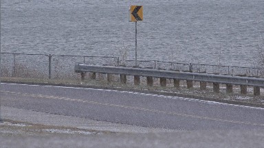 WESTMINSTER COLORADO-2015: Oncoming Traffic Around A Bend With Roadside Near Water