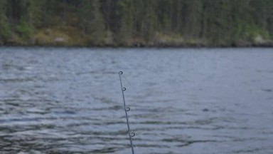 RED LAKE CANADA-2015: Camera Focuses On Top Of Fishing Pole Water Surface
