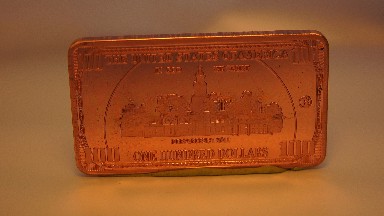 A Rectangular One Hundred Dollar Coin Rotating In A Clockwise Motion