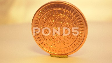 Beautiful Shiny Gold Coin Spinning On Small Thin Yellow Display