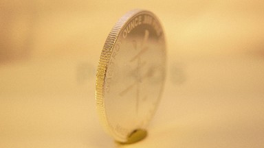 One Troy Ounce Fine Silver Coin Spinning While In A White Background