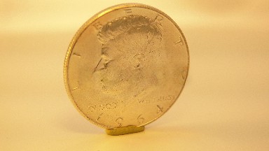 Rotation Gold Quaker Coin Set Up Vertical On Small Stand