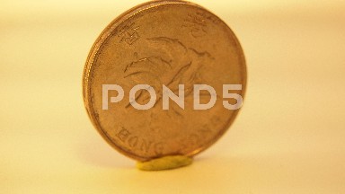 Close-Up And Spin Around A Golden Coin With Affixed Vertically To A Surface