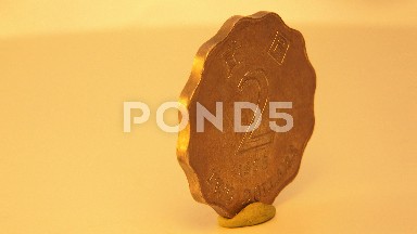 There Is An Old Golden Coin With Some Chinese Markings And The Number Two