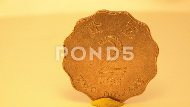 A Gold Coin On A Small Rotating Table With The Number On One Side