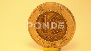 Old And Yellow American Coin Of Ten Dollars Being Showcased