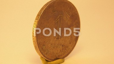 Camera Rotates Showing A Coin That Seems To Be Antique
