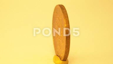 A Gold Coin With A Value Is Rotating Around The Screen Of A Yellow Background