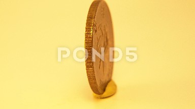 A Golden Coin Spinning Around In A Circle In A Public Zone That Says Hong Kong
