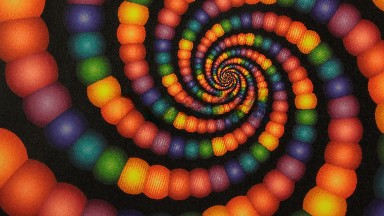 A Clockwise Spiral Of Rainbow Color Beads In A Black Background