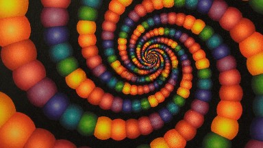 An Optical Illusion Of A Rainbow Amount Of Colors Of Balls Spinning In A