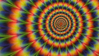 Rainbow Colored Pattern Twirls On Screen Pattern Gets Smaller Closer To The