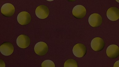 Yellow Balls On A Wine Background With The Image Swirling Constantly