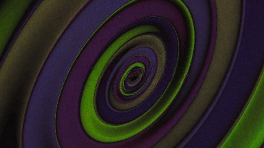 A Disk Composed Of Concentric Spirals Displaying The Colors Of Purple Blue Green