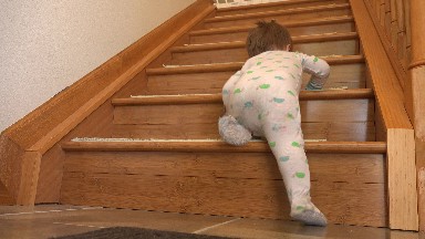 WESTMINSTER COLORADO-2015: Baby Climbing Wooden Stairs With Baby Gate At Top